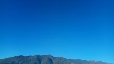 A peaceful view of the Atlas Mountains under a clear blue sky.