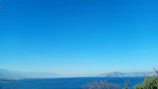 View from the cabin veranda overlooking the serene beach and distant mountains.