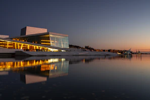 An elegant modern waterfront residential complex in Athens bathed in golden hour light.