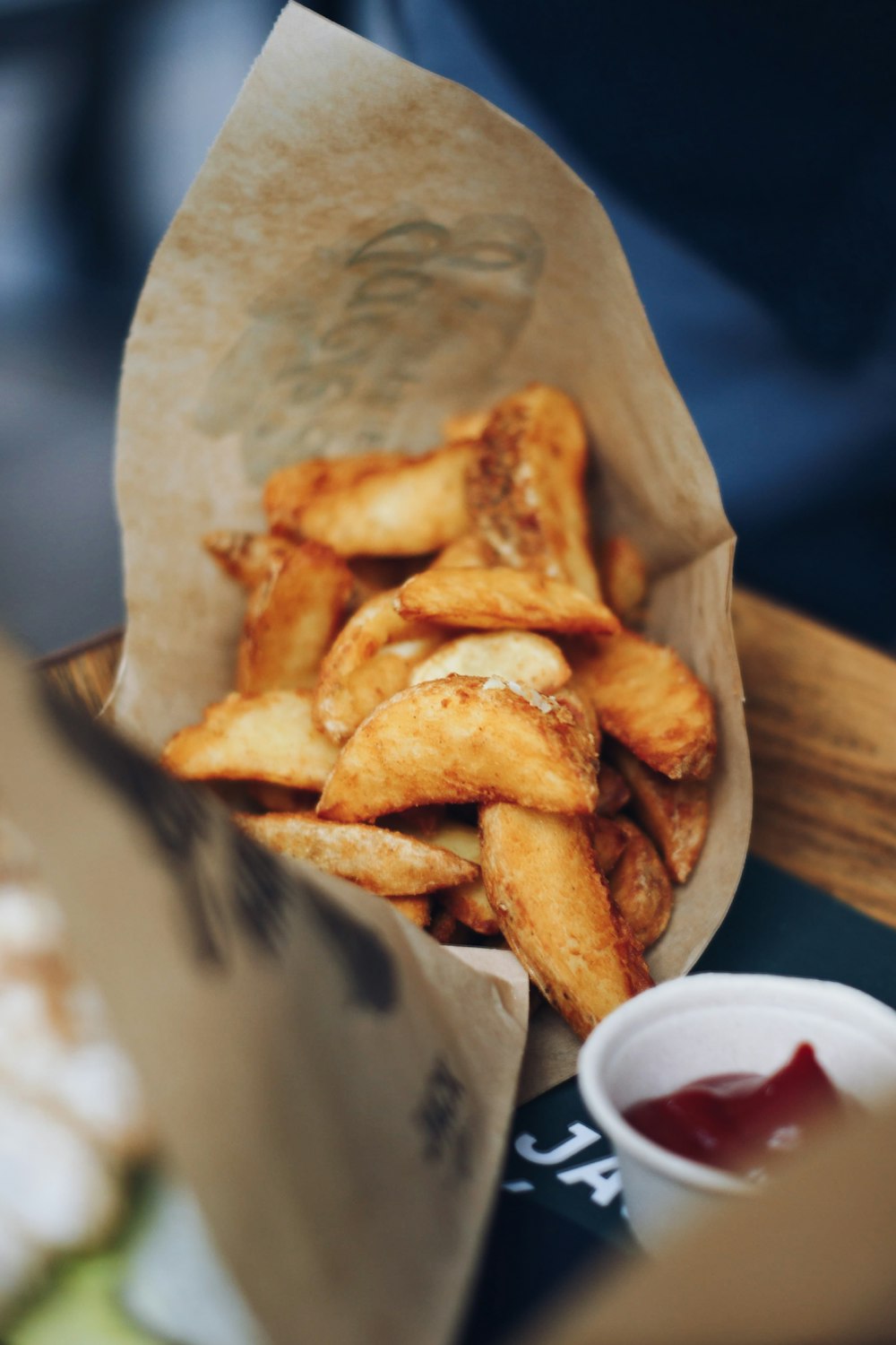 a basket of french fries with ketchup and ketchup