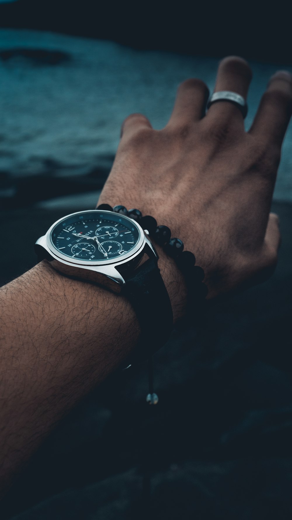 round silver-colored chronograph watch with black strap