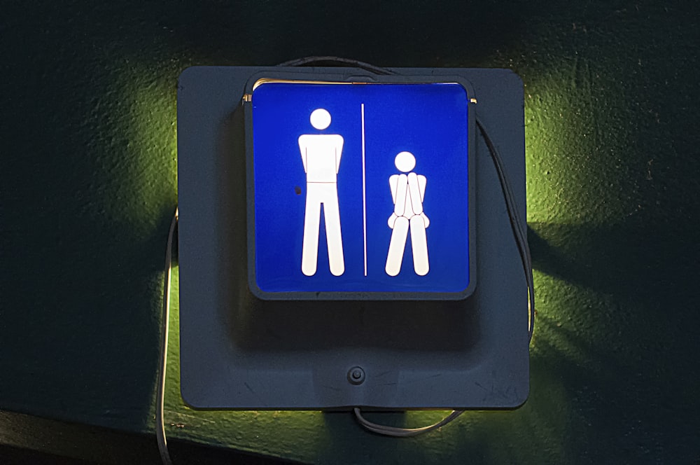 a blue sign with a man and a woman on it
