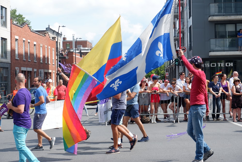 people walking on road while holding flags