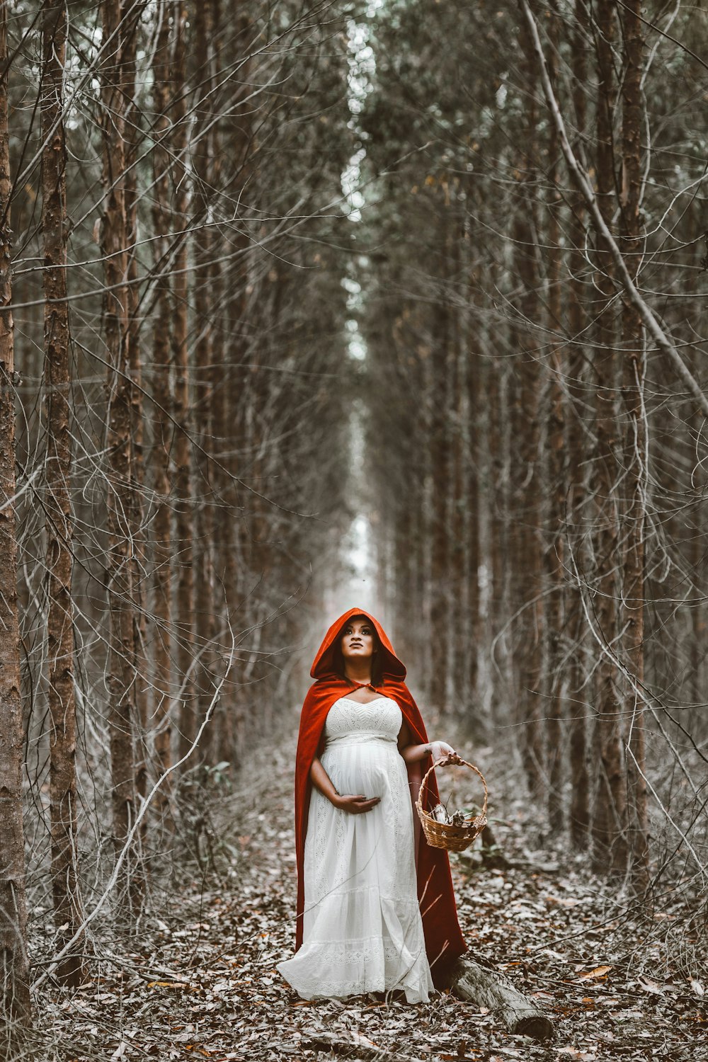 woman holding basket standing on pathway