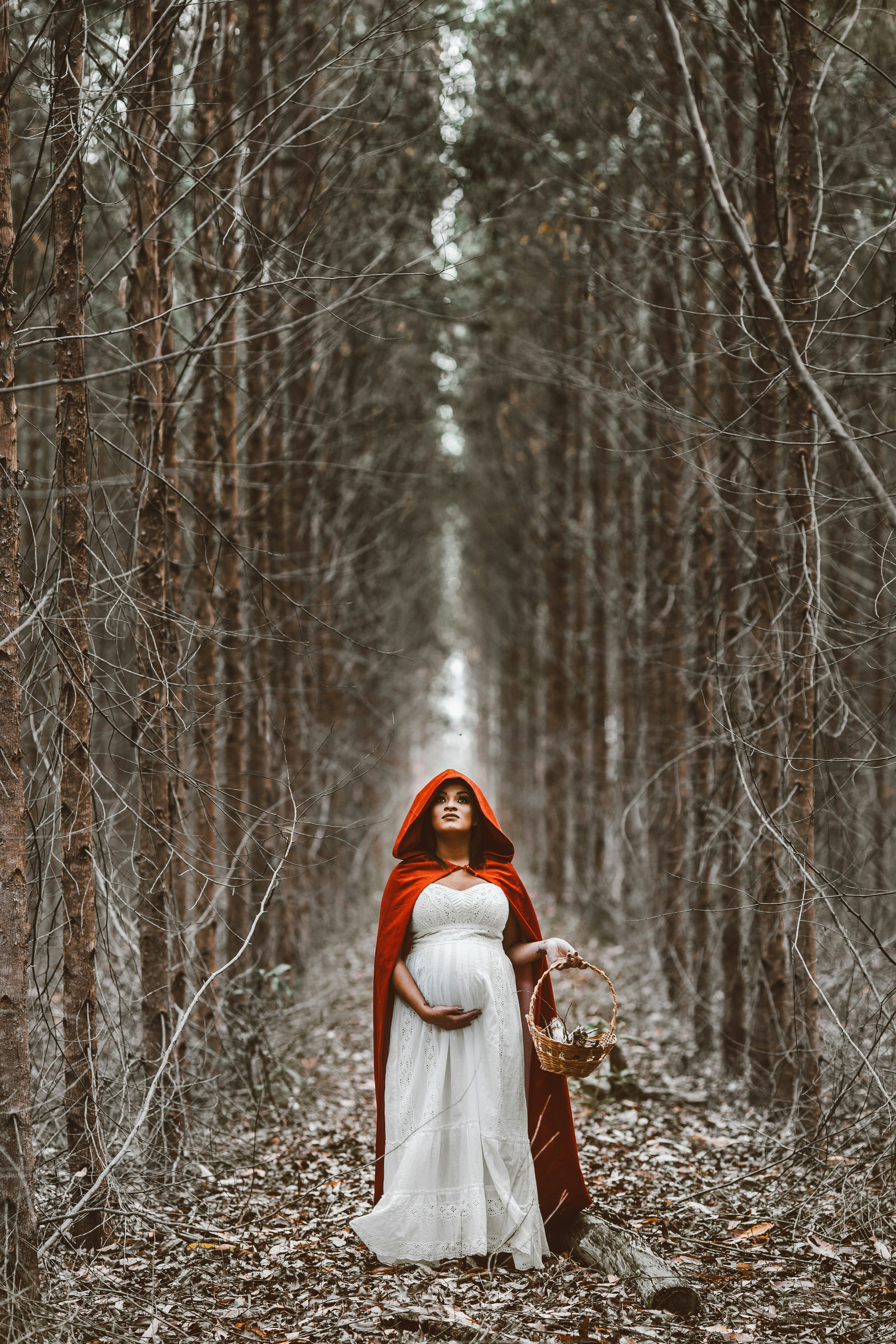 woman holding basket standing on pathway