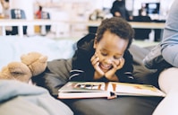 boy smiling and reading book