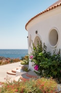 white concrete house near sea during daytime