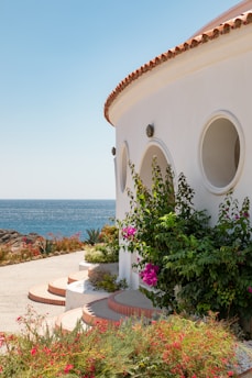 white concrete house near sea during daytime