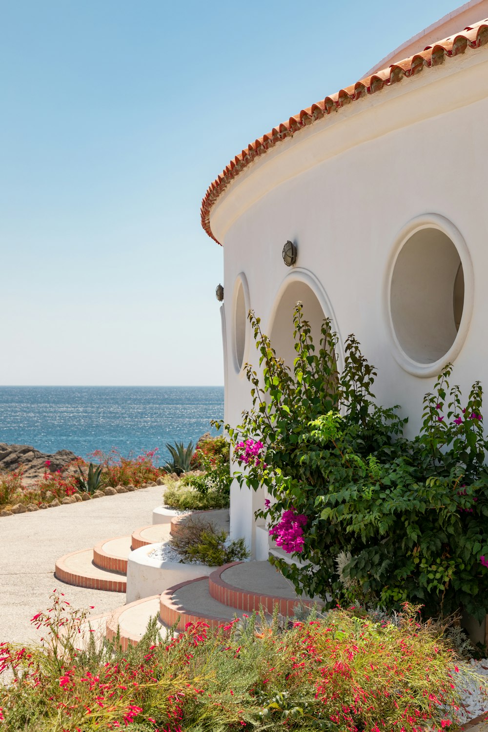 white concrete house near sea during daytime