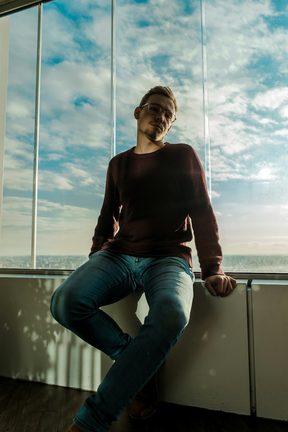 man sitting beside wall