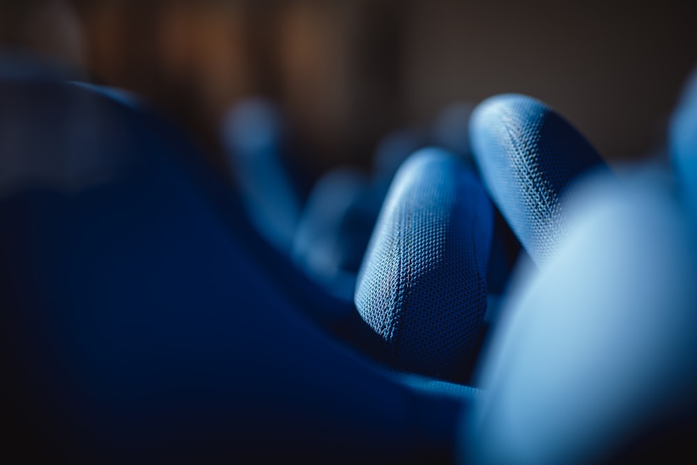 a close up of a blue chair with a blurry background