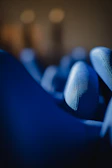 Soft focus shot of textured urban fabric draped over a chair, spotlighted by neon signage.