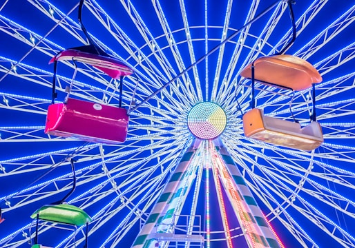 Colorful spinning wheel with bright segments and a glowing pointer.