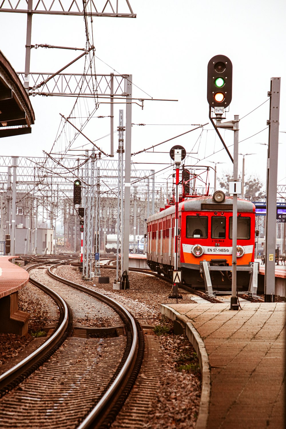 red train on railway during daytime