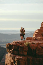 A warm handshake between two business professionals against a backdrop of red sandstone cliffs.