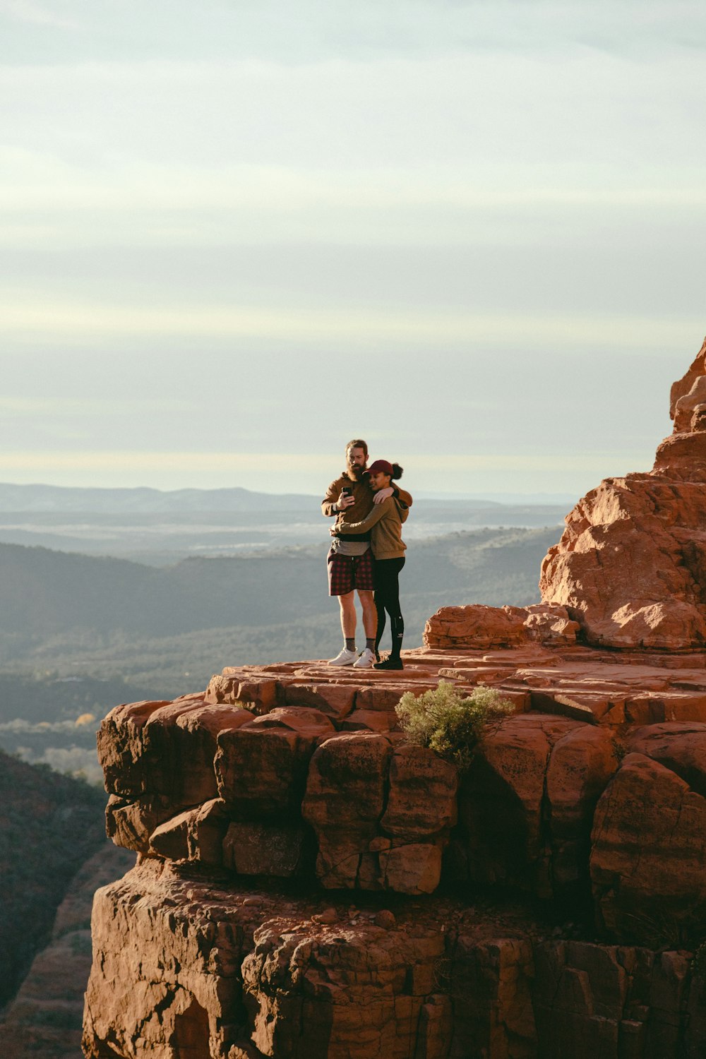 man and woman hugging on cliff during daytime
