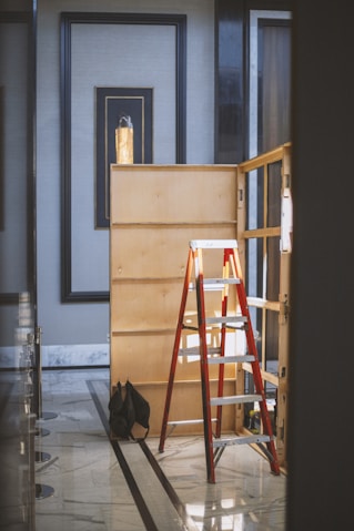 orange and gray folding ladder on floor