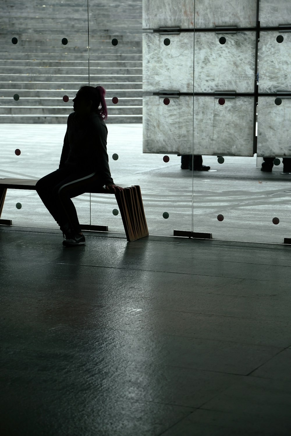 Man Wearing Black Trench Coat And Black Pants Sitting On Bench