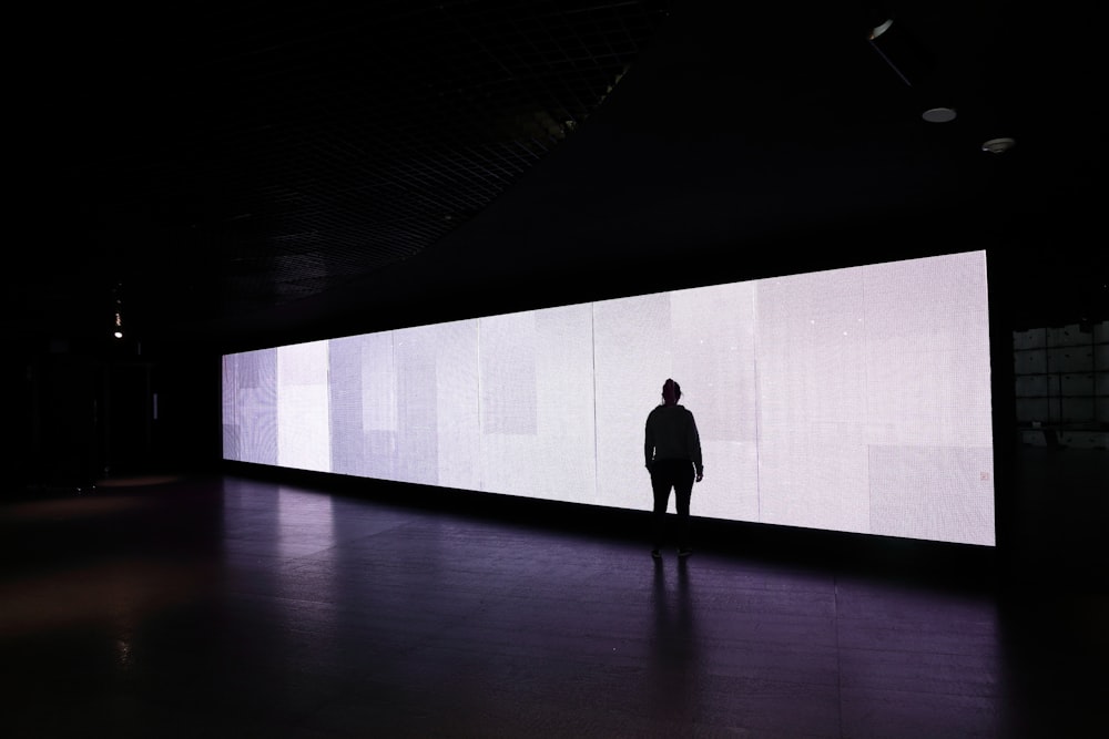 standing person in front of rectangular board