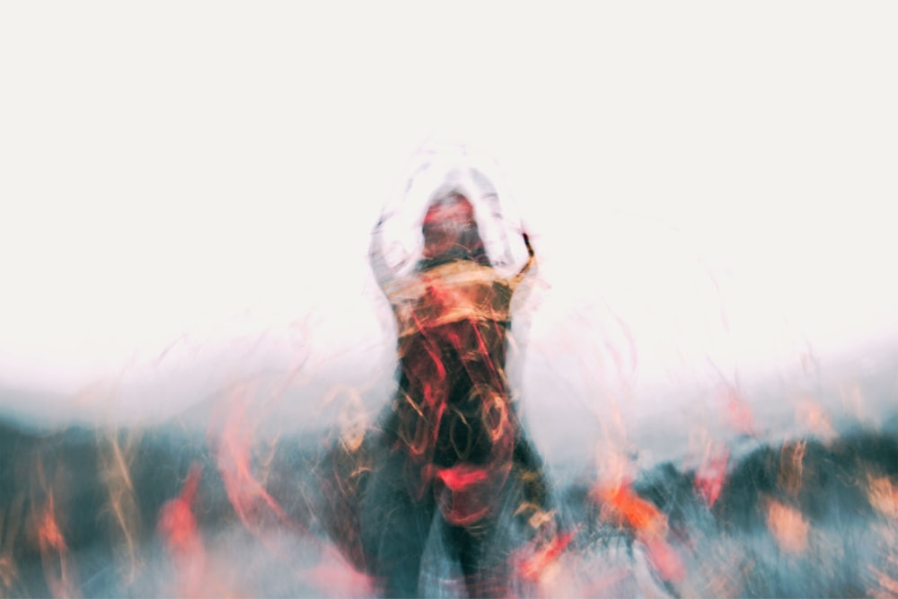 a blurry photo of a person with their hands in the air