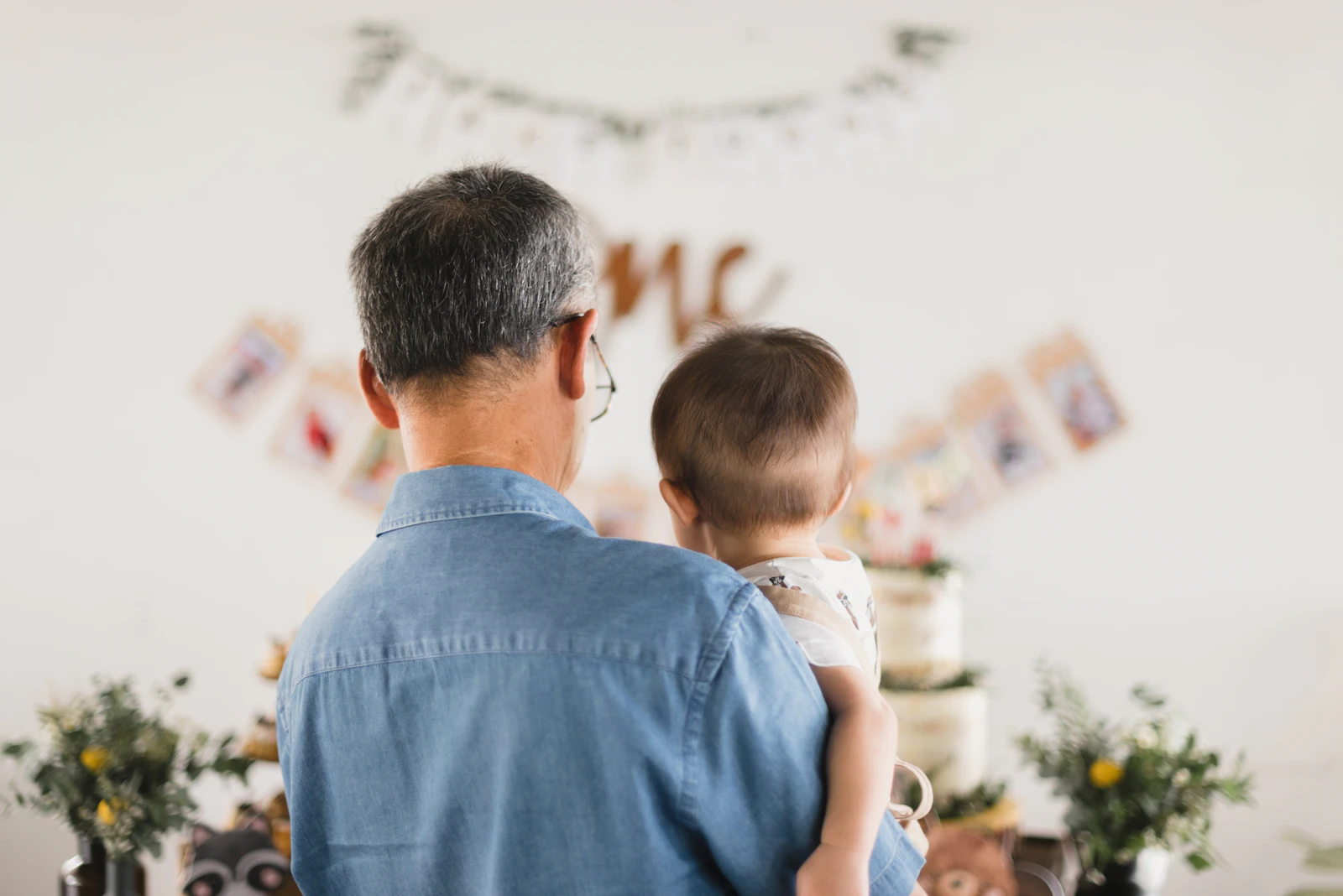 Dad holding his baby at a party