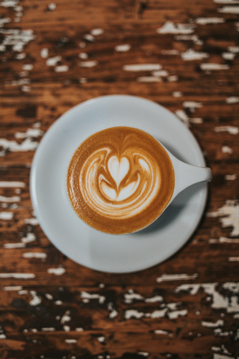 white ceramic coffee cup with cappuccino