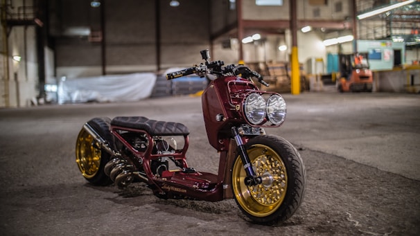 A customized motorcycle with vibrant paint and unique accessories in a garage setting.