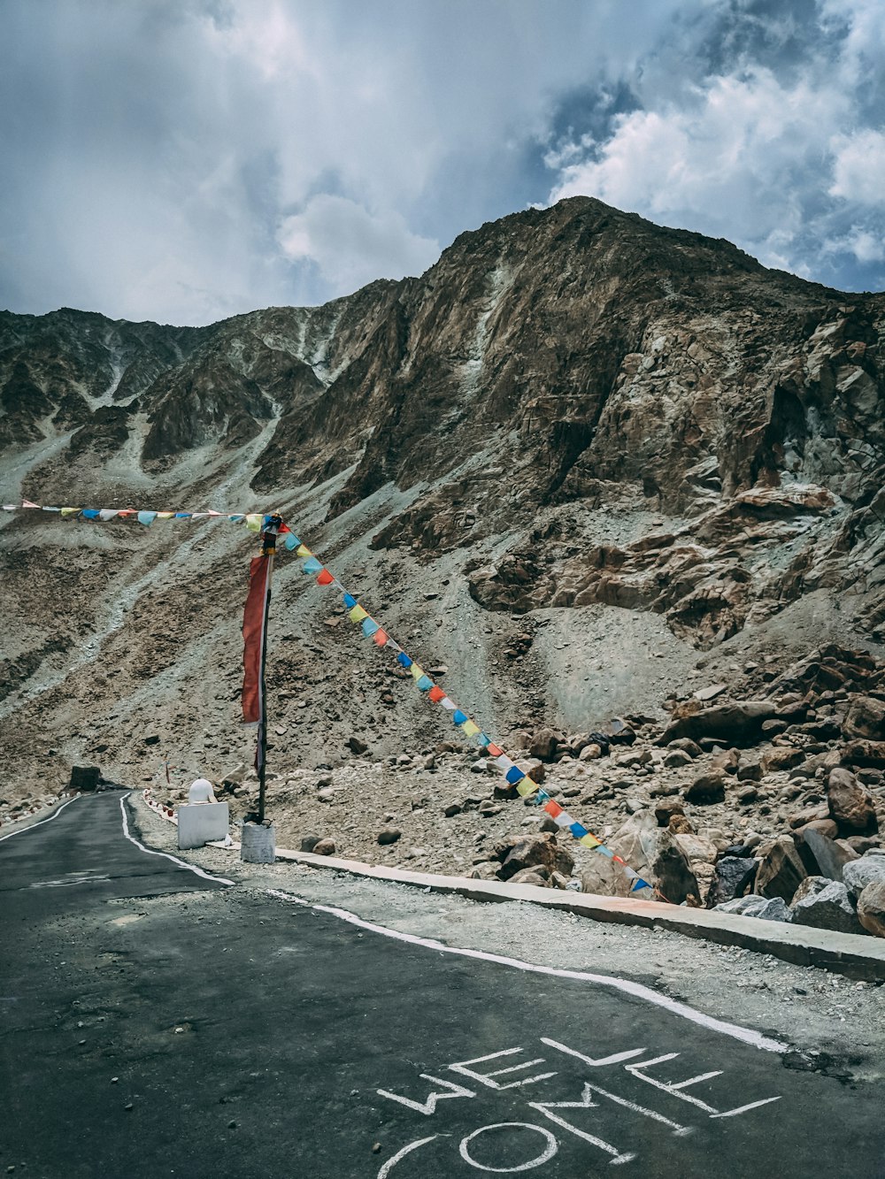 asphalt road way beside mountain during daytime