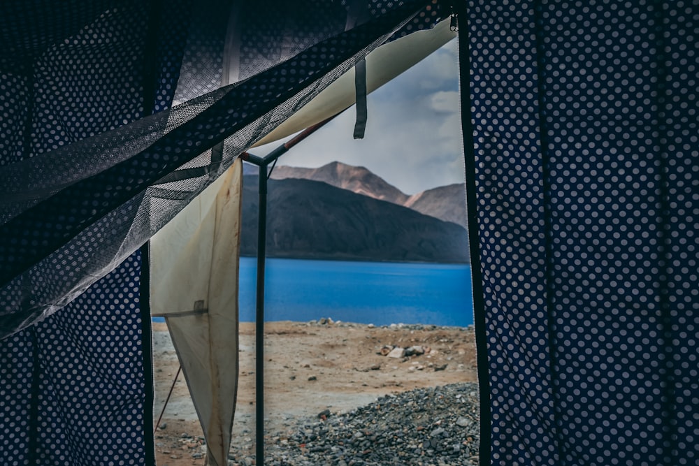 gray shed beside body of water