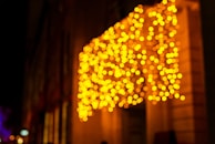 Evening shot of a community festival with warm orange-yellow lighting and subtle black streak decorations.