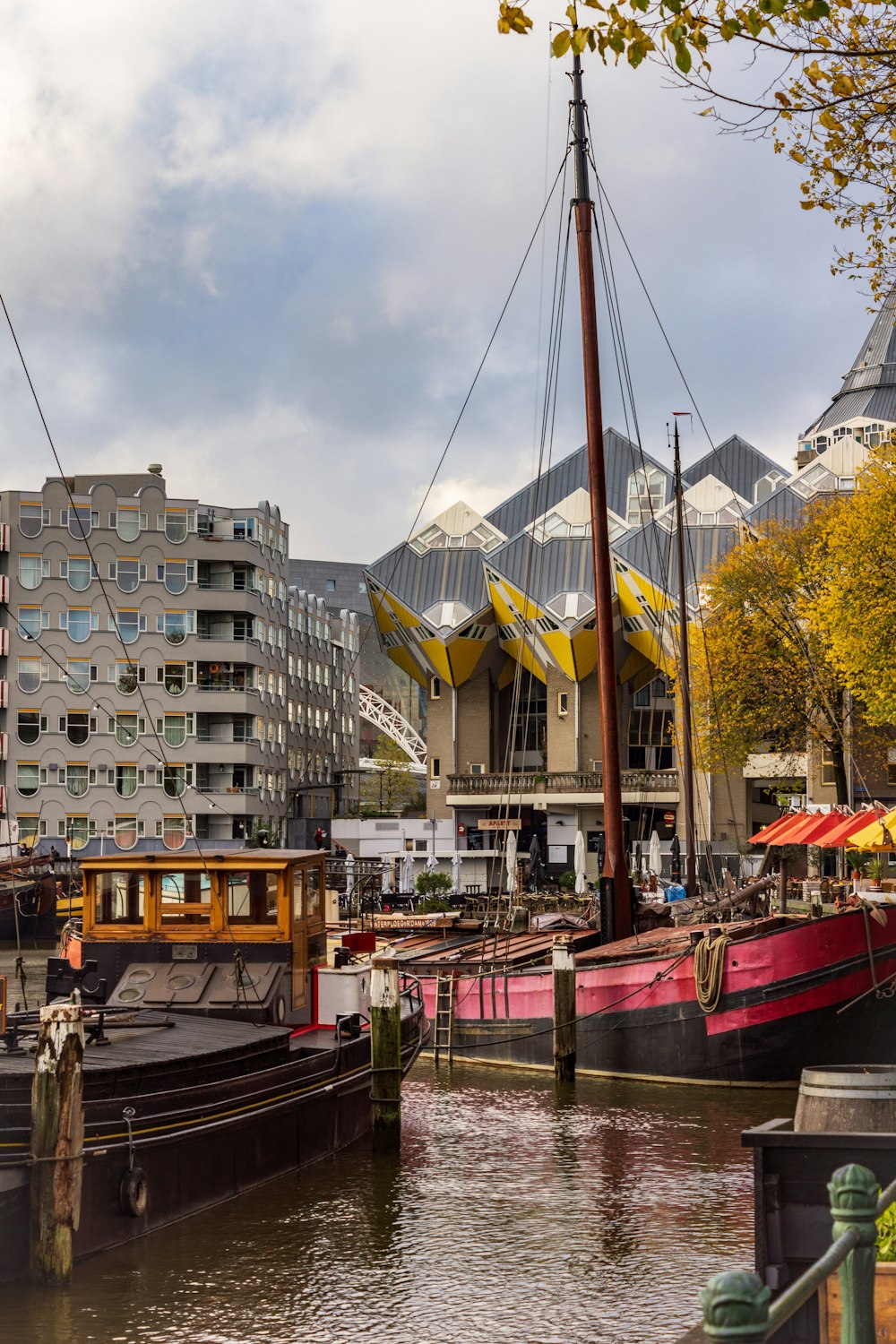 different boats on body of water near high-rise buildings under white and blue sky