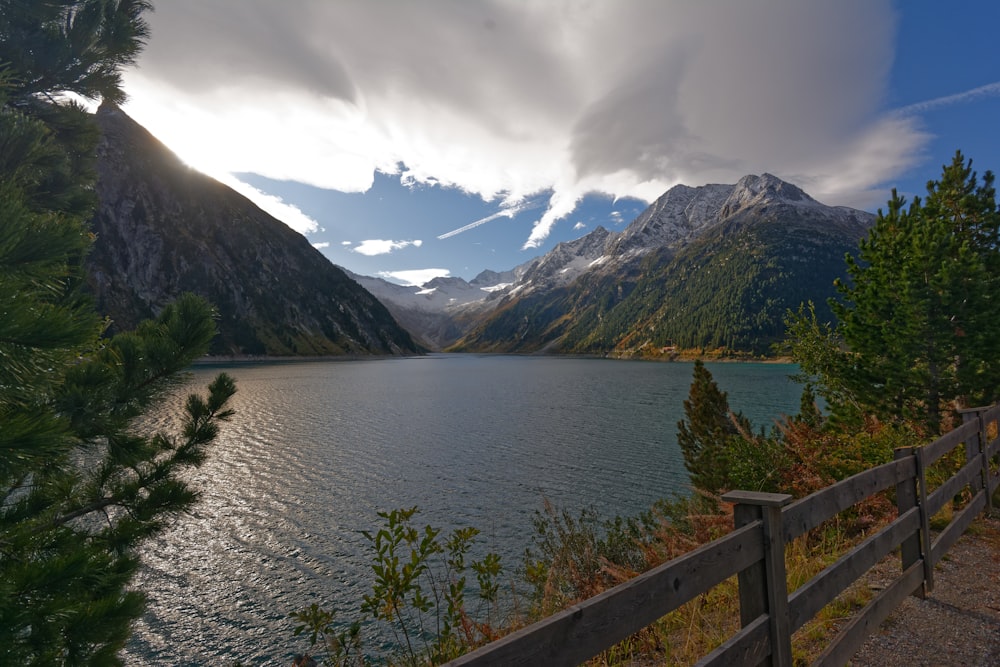 mountains near body of water under cloudy sky