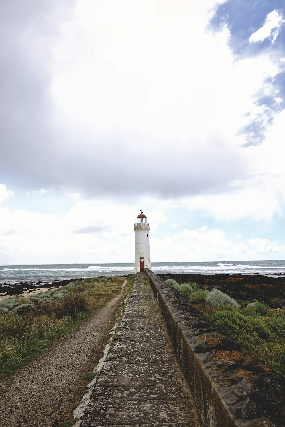 a light house sitting on the side of a road