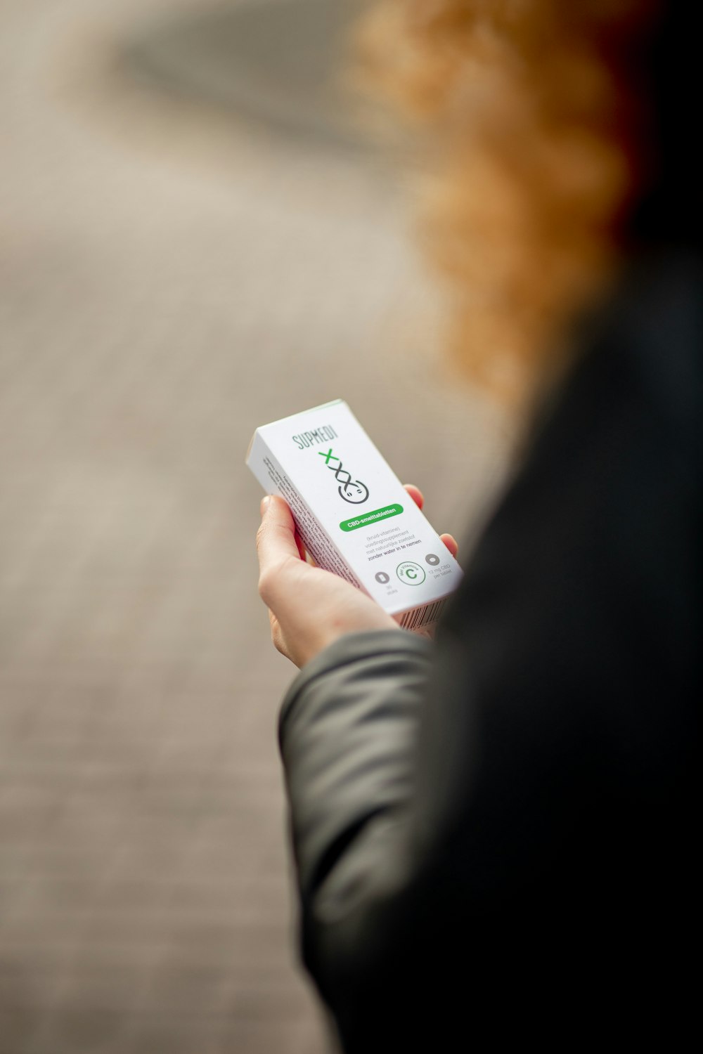 person holding white box