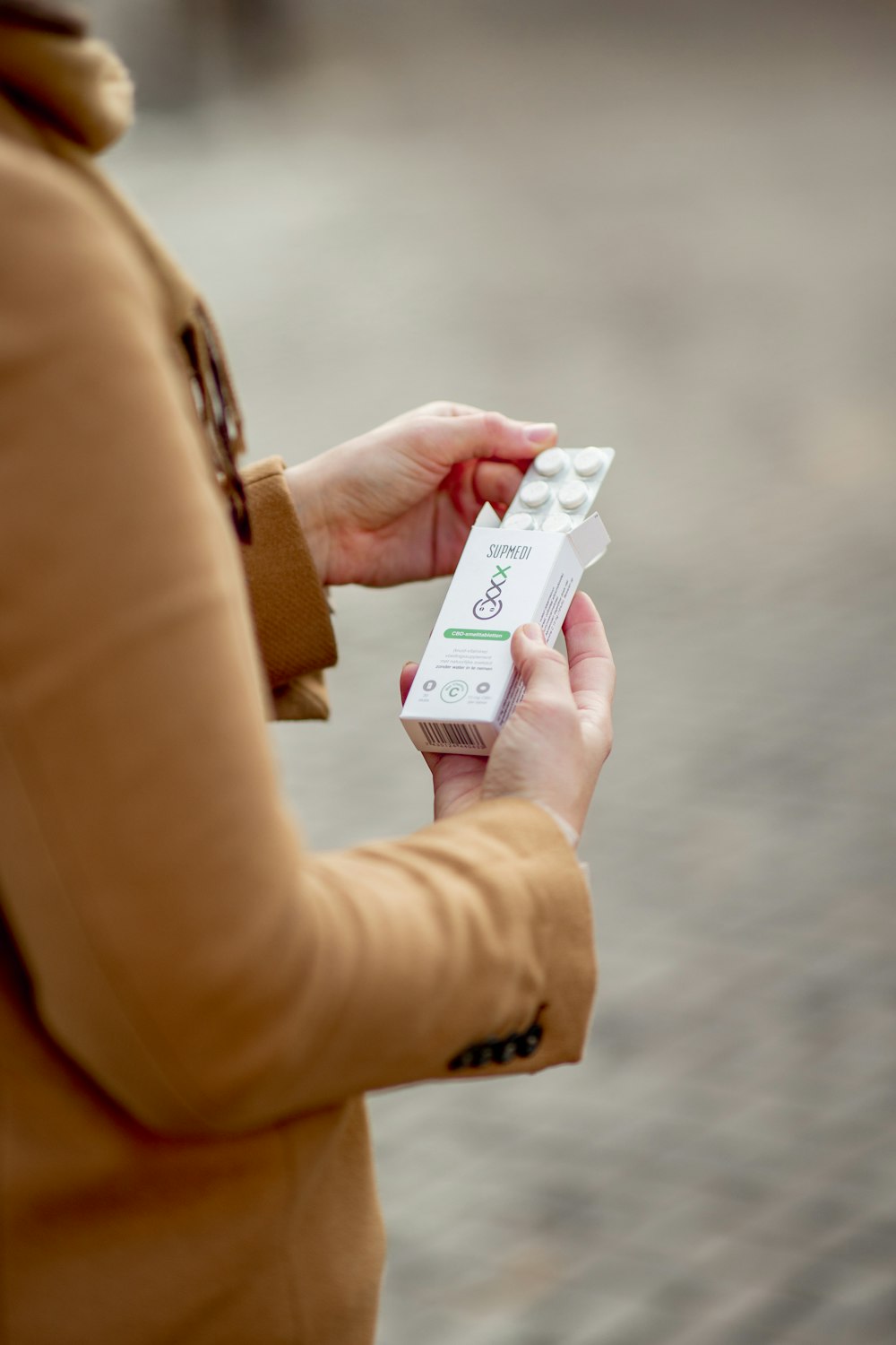 woman holding white and black labeled box