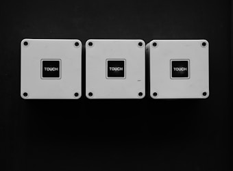 Three square metallic boxes with the word 