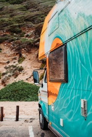 A campervan in the workshop mid-respray, highlighting vibrant lime green detailing.