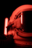 Close-up of a futuristic astronaut helmet reflecting neon blockchain symbols.
