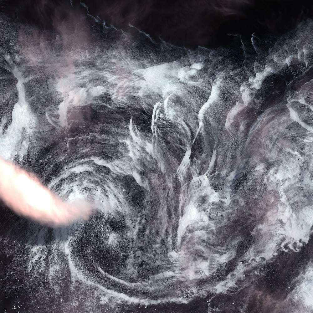 a black and white photo of a swirl of smoke