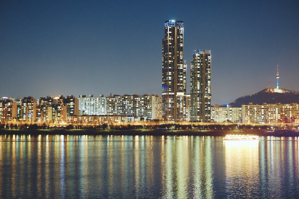 lighted city near body of water during night