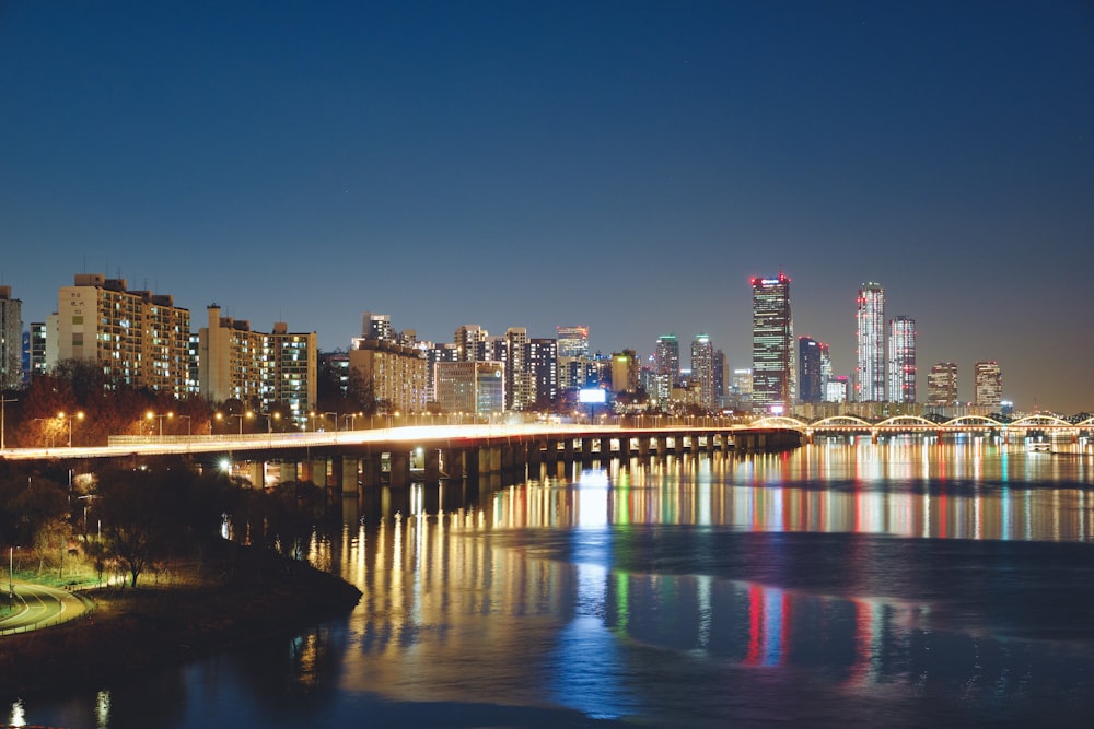 cityscape near body of water during nighttime