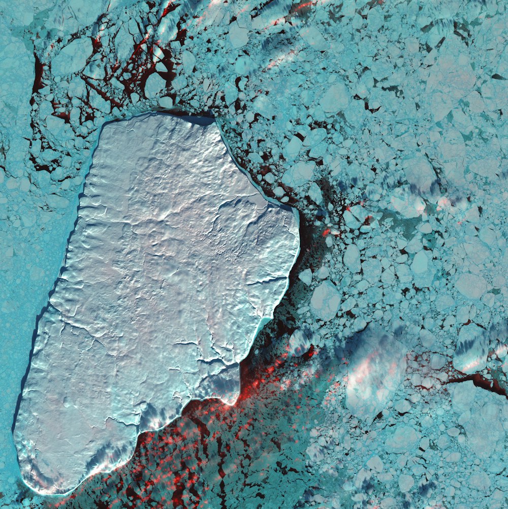 an aerial view of a large iceberg in the ocean