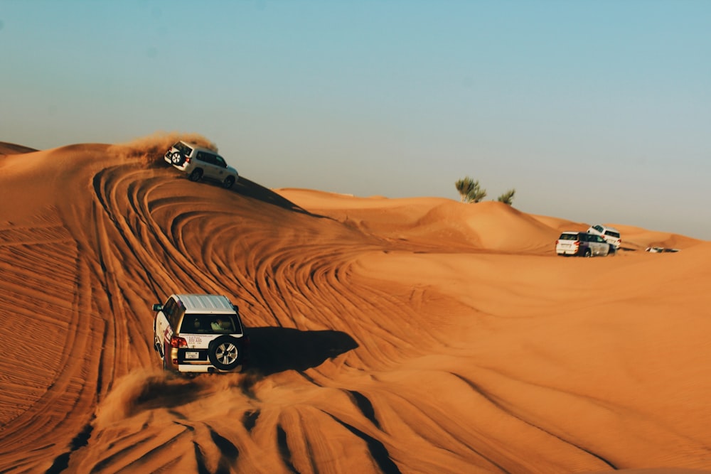vehicles on desert during daytime