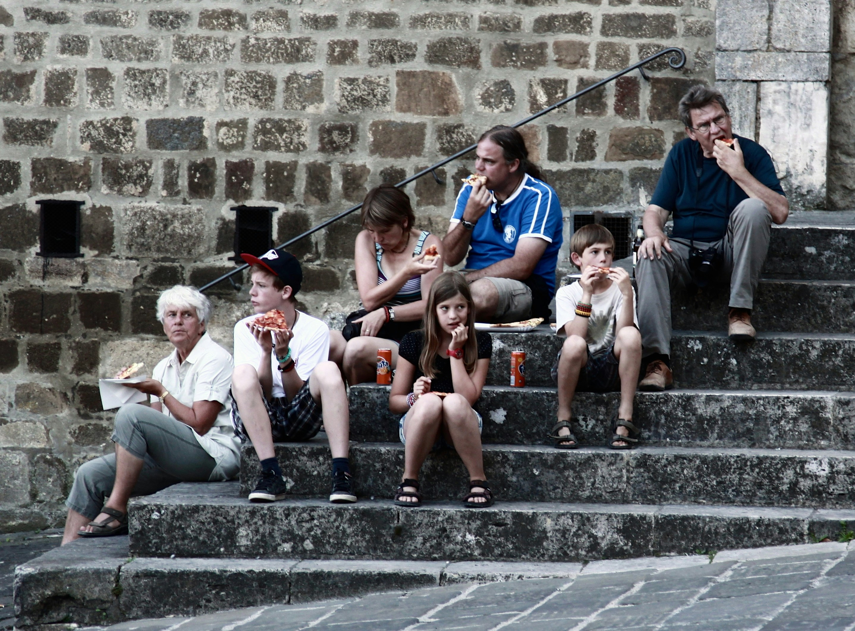 A cargo ship navigating a calm sea, with a visual overlay showing rising global oil prices and a downward trending rupee symbol, indicating economic impact.