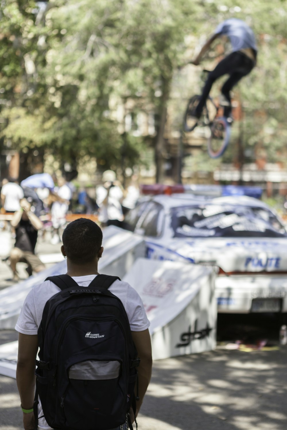 selective focus photography of man watching person doing bike stunt