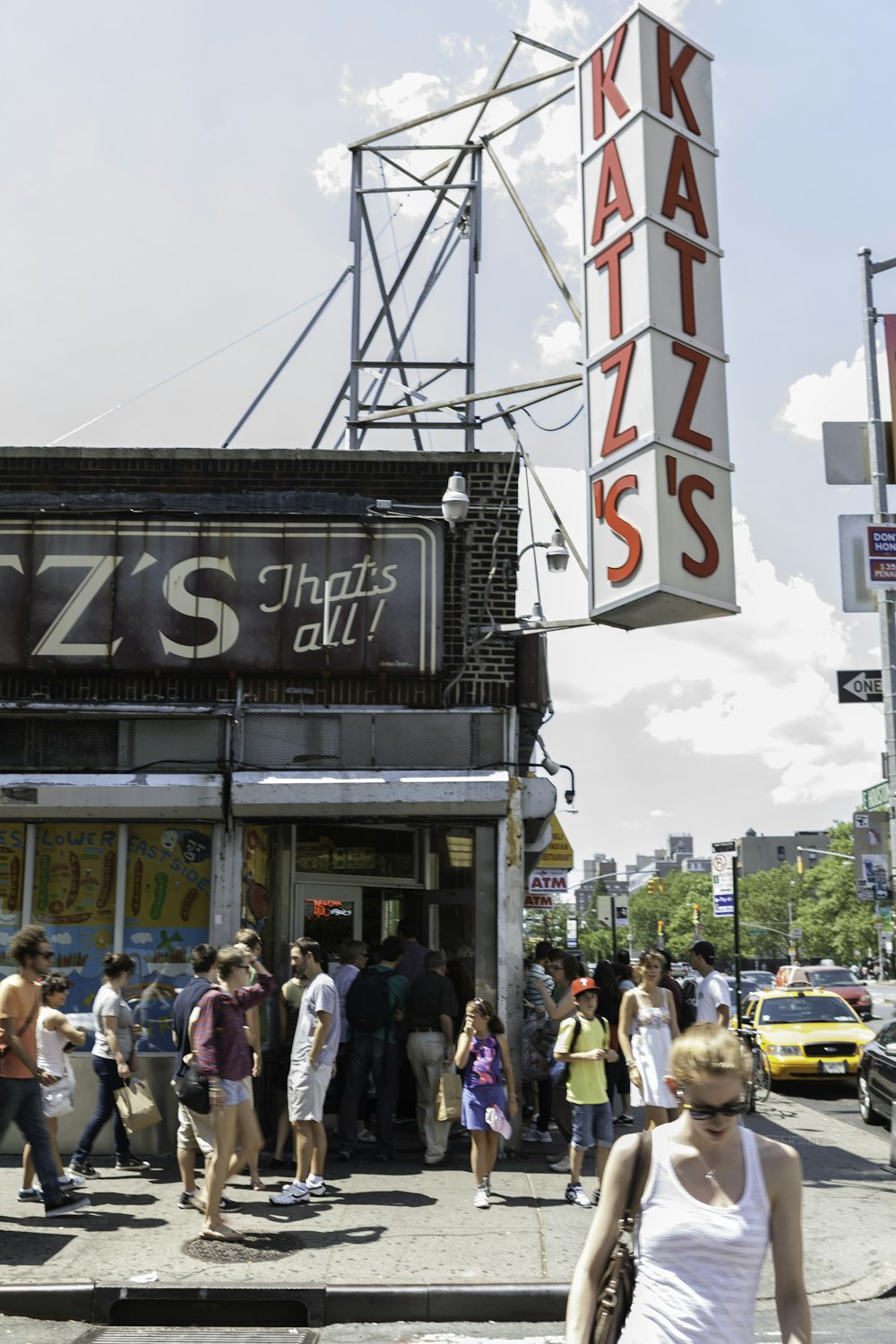 crowd in front of Katz's building during daytime