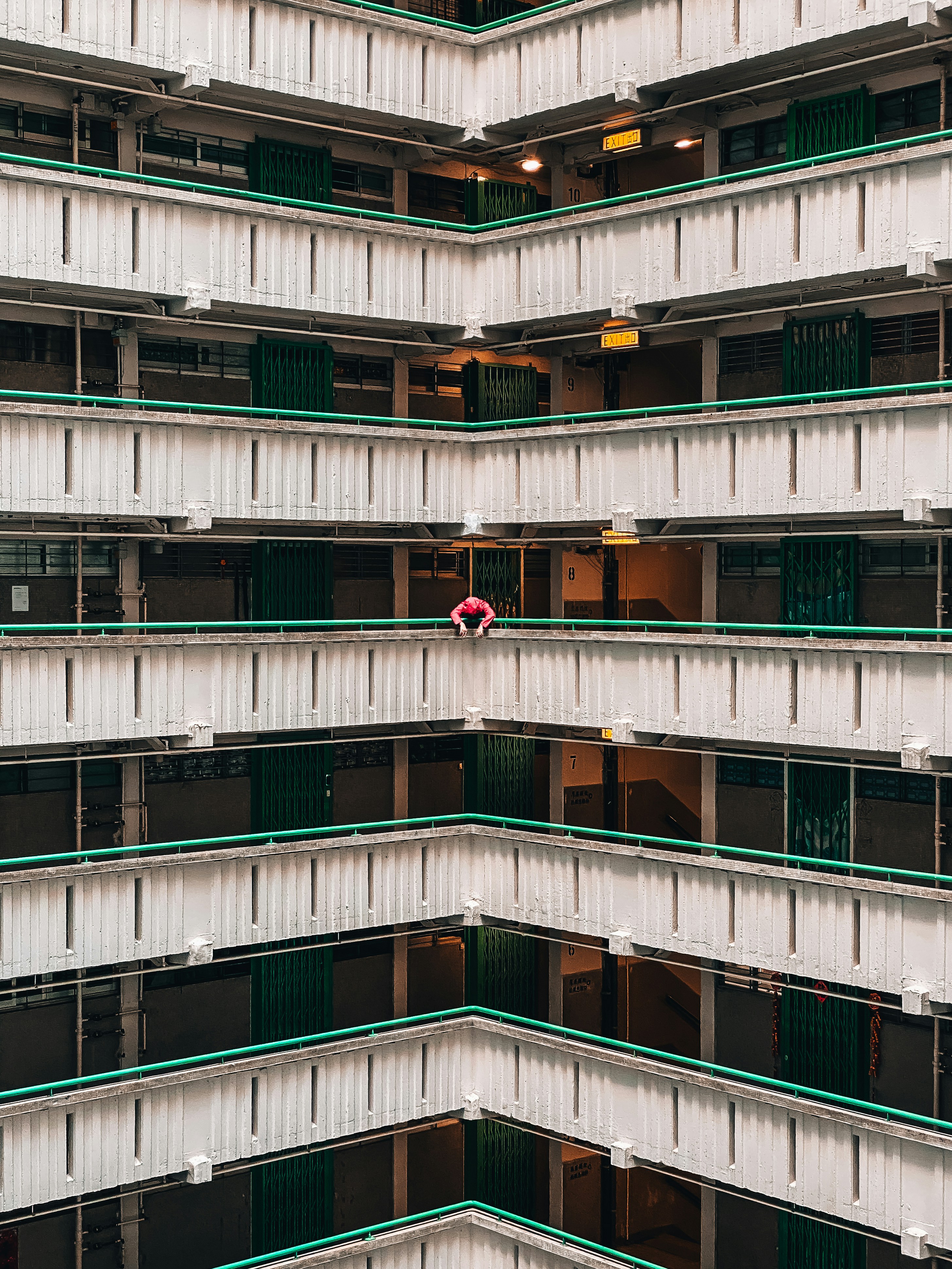 person standing and leaning near high-rise building