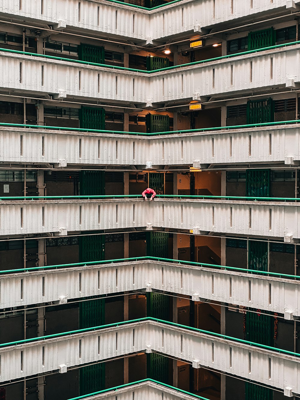 person standing and leaning near high-rise building