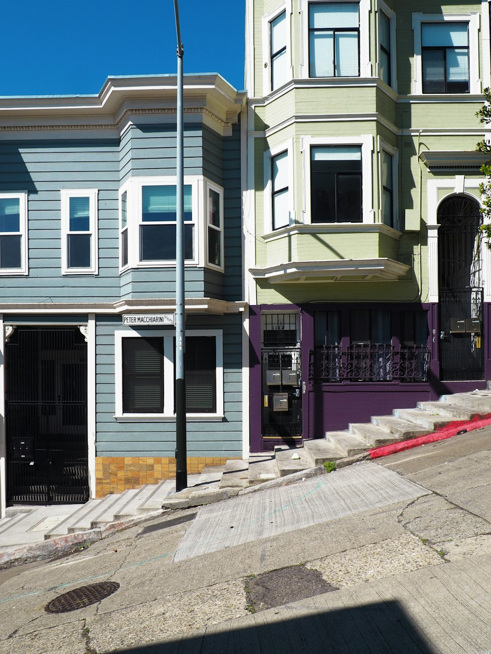 white and blue concrete houses near stairs