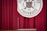 A dark red curtain serves as the backdrop for a podium with a microphone. Behind and slightly above, there is a circular university seal with text and symbols.
